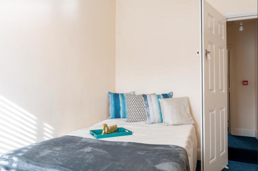 A cozy double bedroom featuring large windows t...