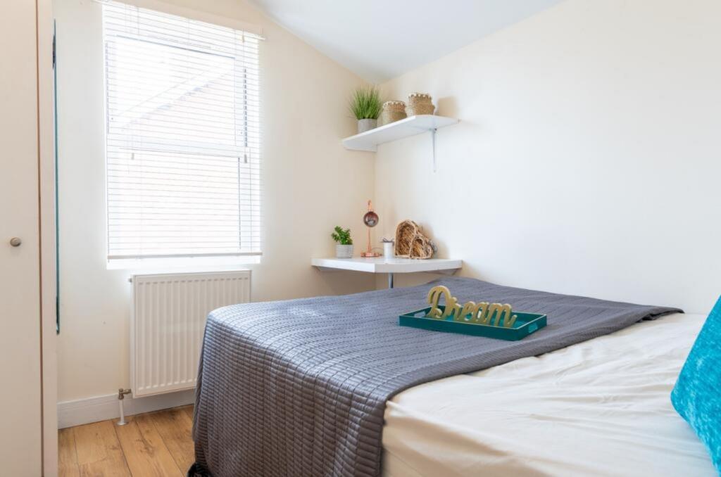 Cozy double bedroom featuring a comfortable bed...