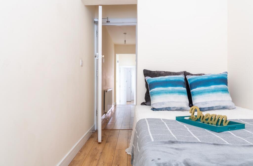 Bright and cozy double bedroom featuring stylis...