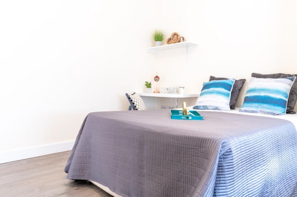 This inviting double bedroom features tasteful ...