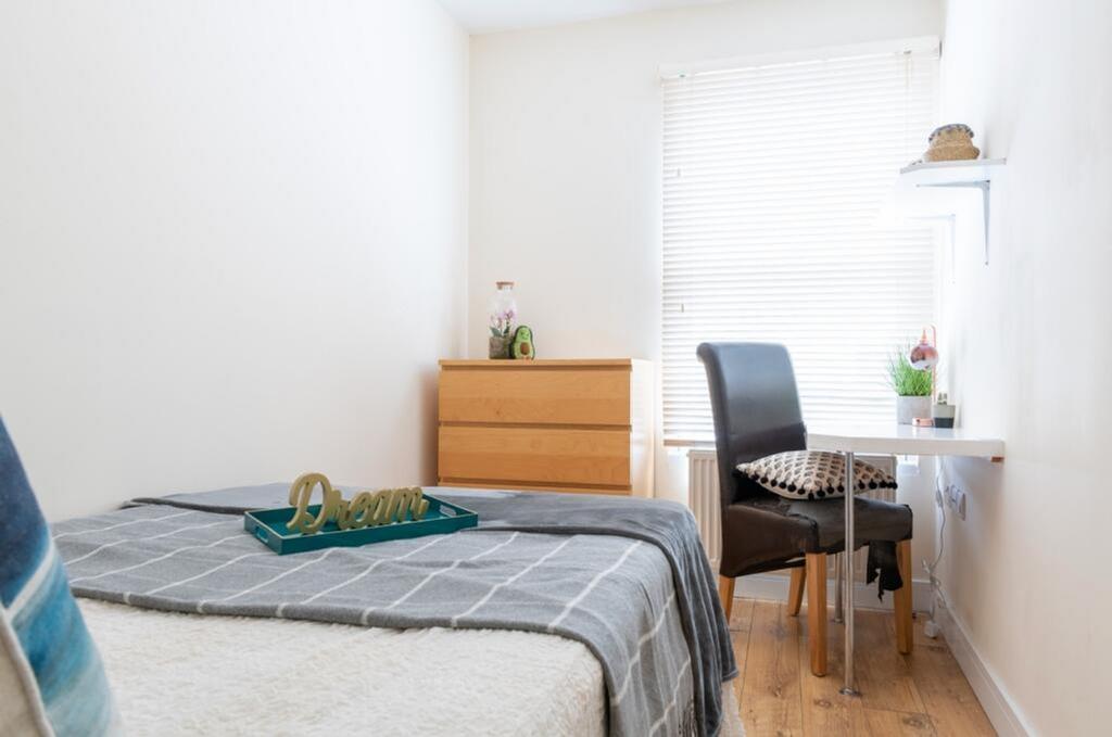 This stylish double bedroom features a comforta...