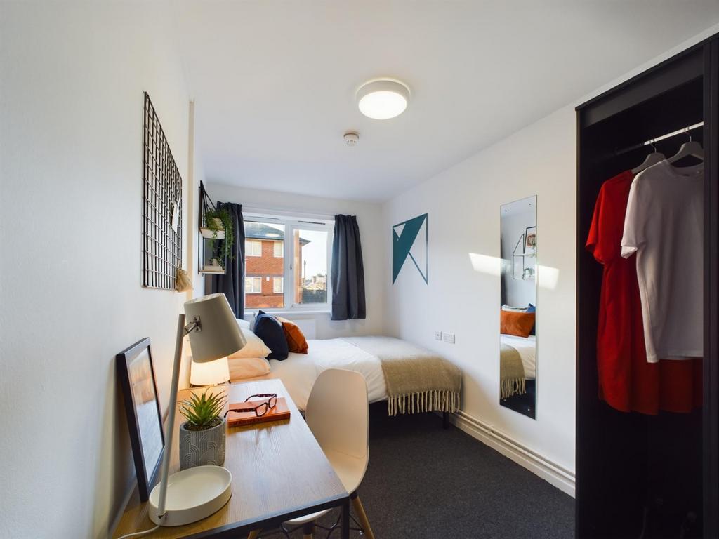 A bright and inviting double bedroom featuring ...