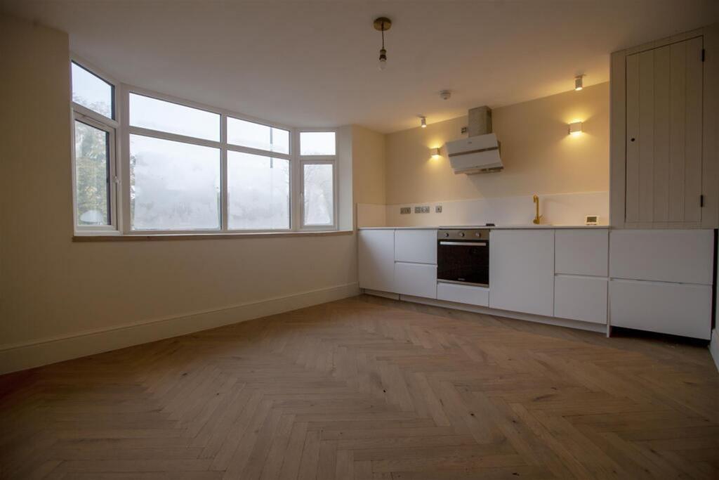 This modern kitchen features a spacious layout ...