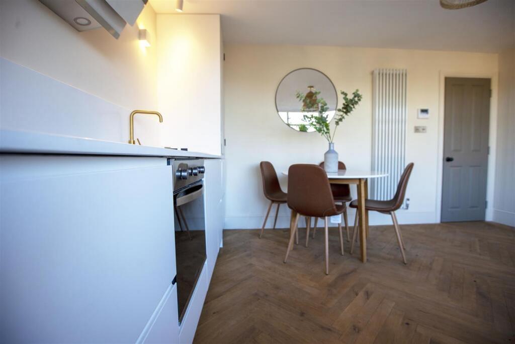 Modern kitchen featuring stylish cabinetry, a s...