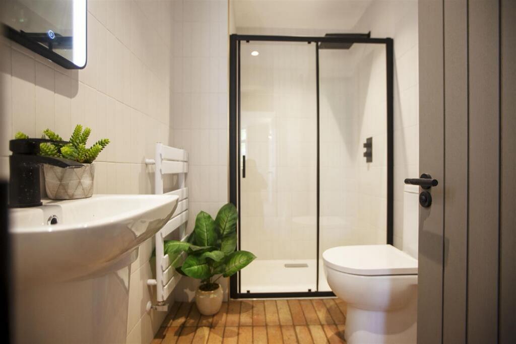 A modern bathroom featuring a stylish shower en...