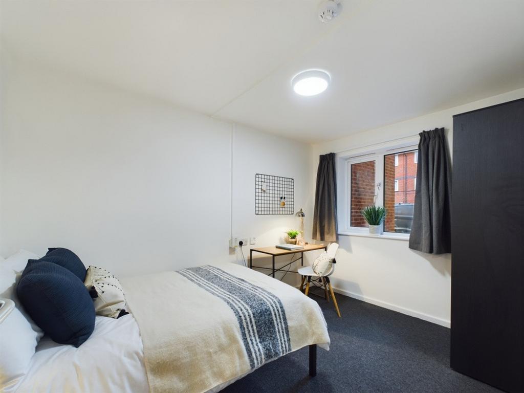 A bright and inviting double bedroom featuring ...