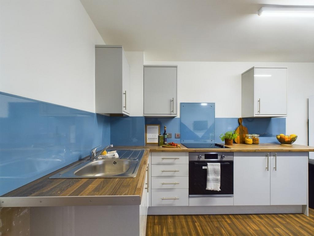 A bright and modern kitchen with ample storage ...