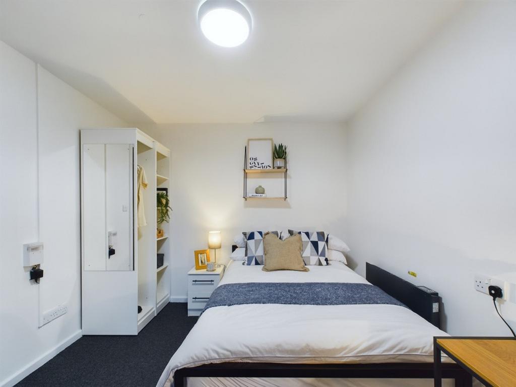 A bright and inviting double bedroom featuring ...