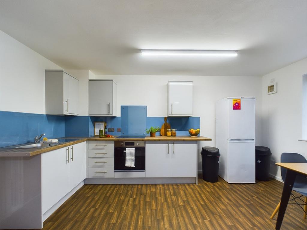 A spacious and modern kitchen with sleek cabine...