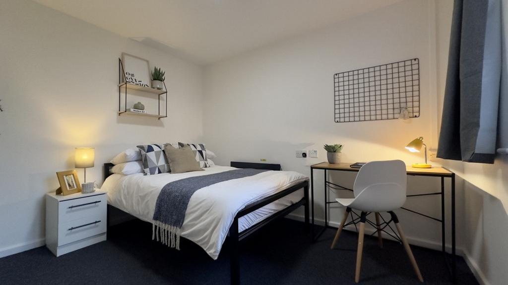 A bright and inviting double bedroom featuring ...
