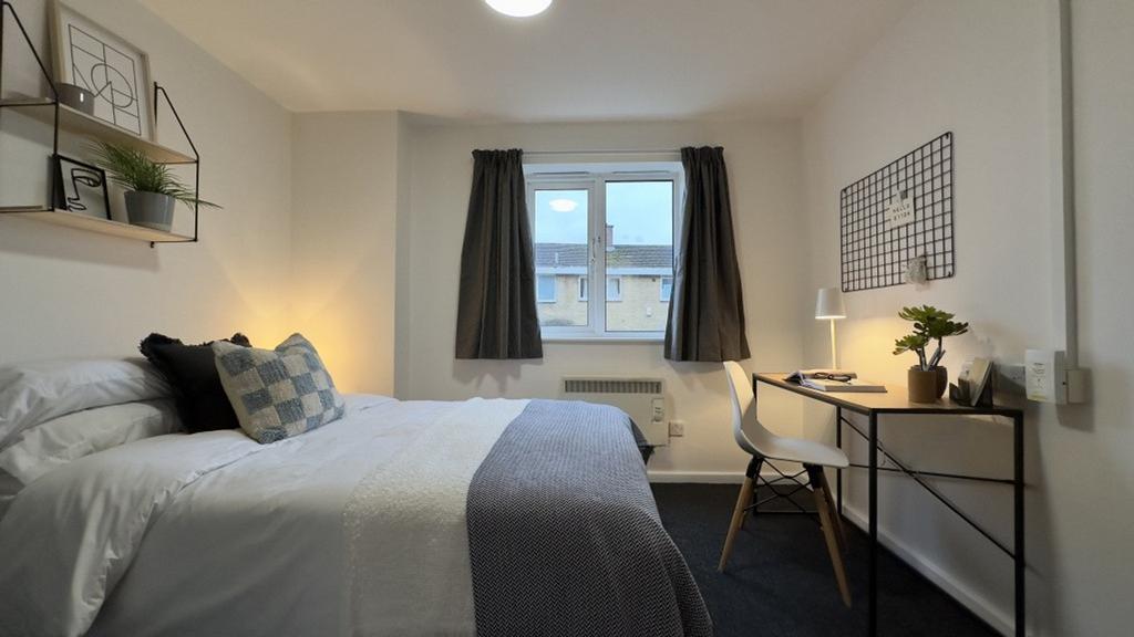 A bright and inviting double bedroom featuring ...