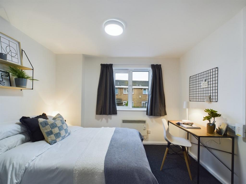 A bright and inviting double bedroom featuring ...