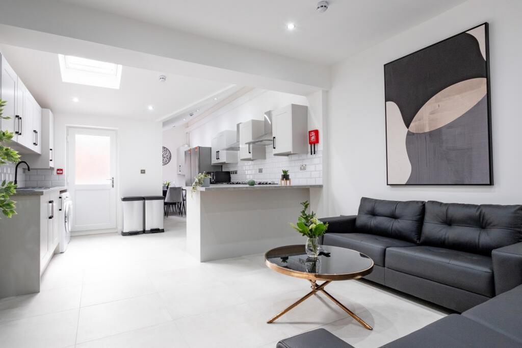 A spacious and modern living room featuring sty...