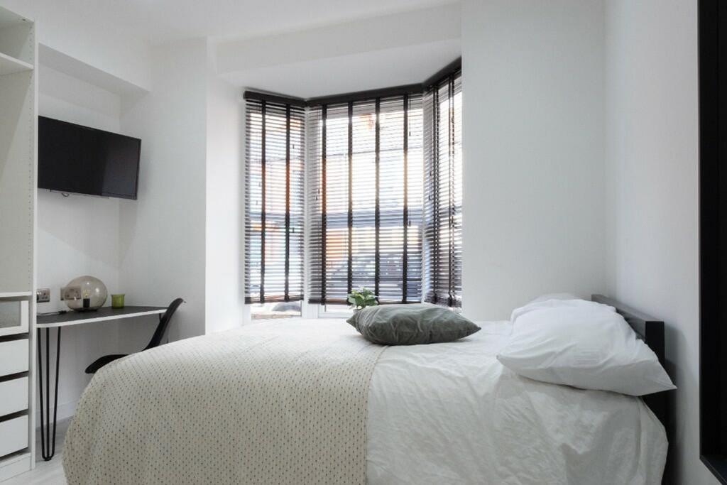 A bright and inviting double bedroom featuring ...