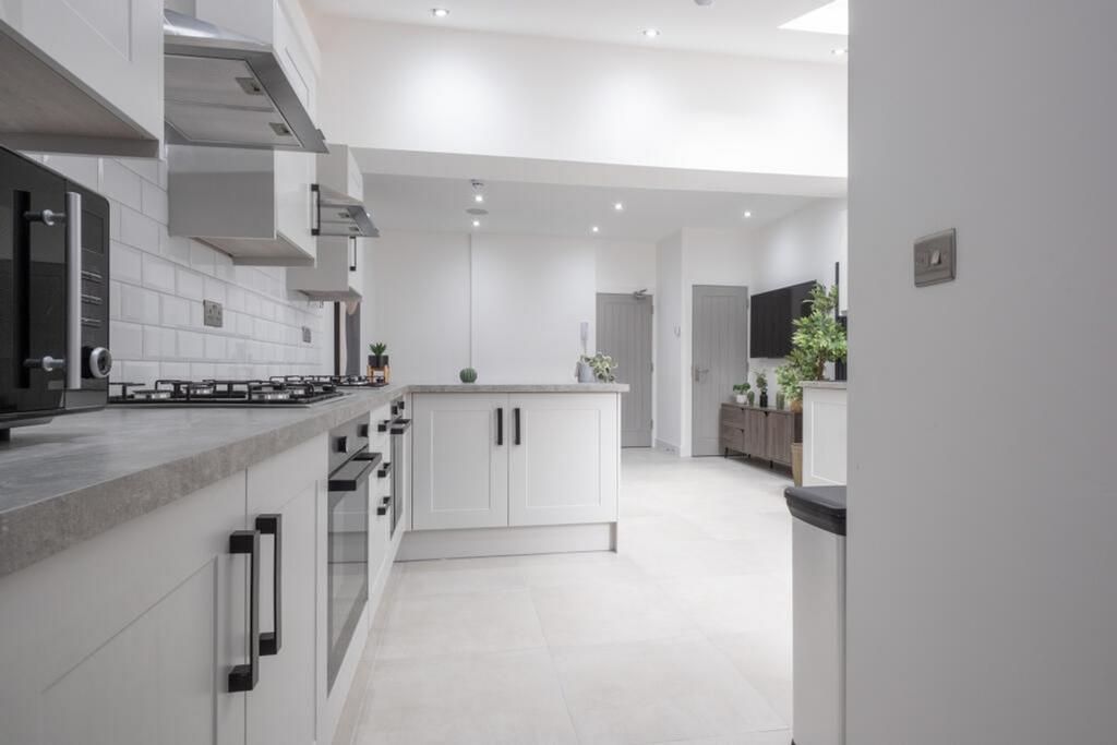 A spacious and modern kitchen with ample natura...