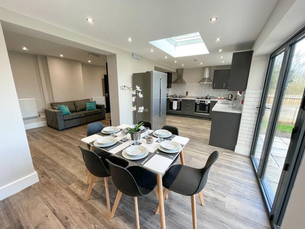 A modern kitchen and dining area featuring a st...