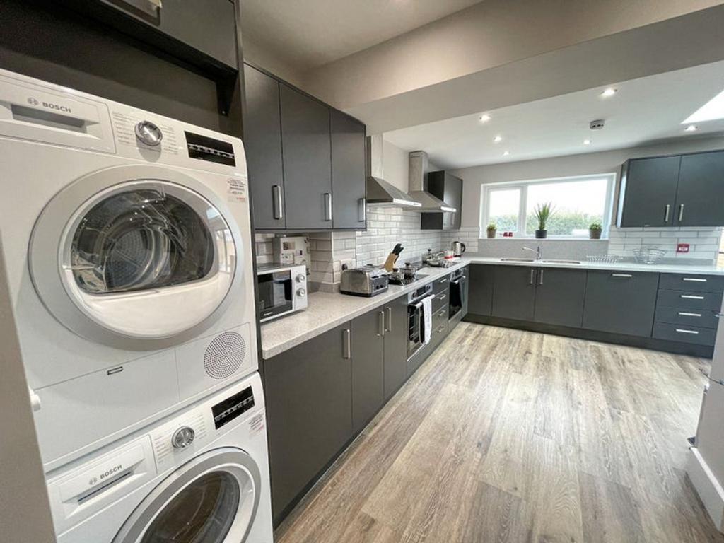 Modern kitchen featuring sleek cabinetry, ample...