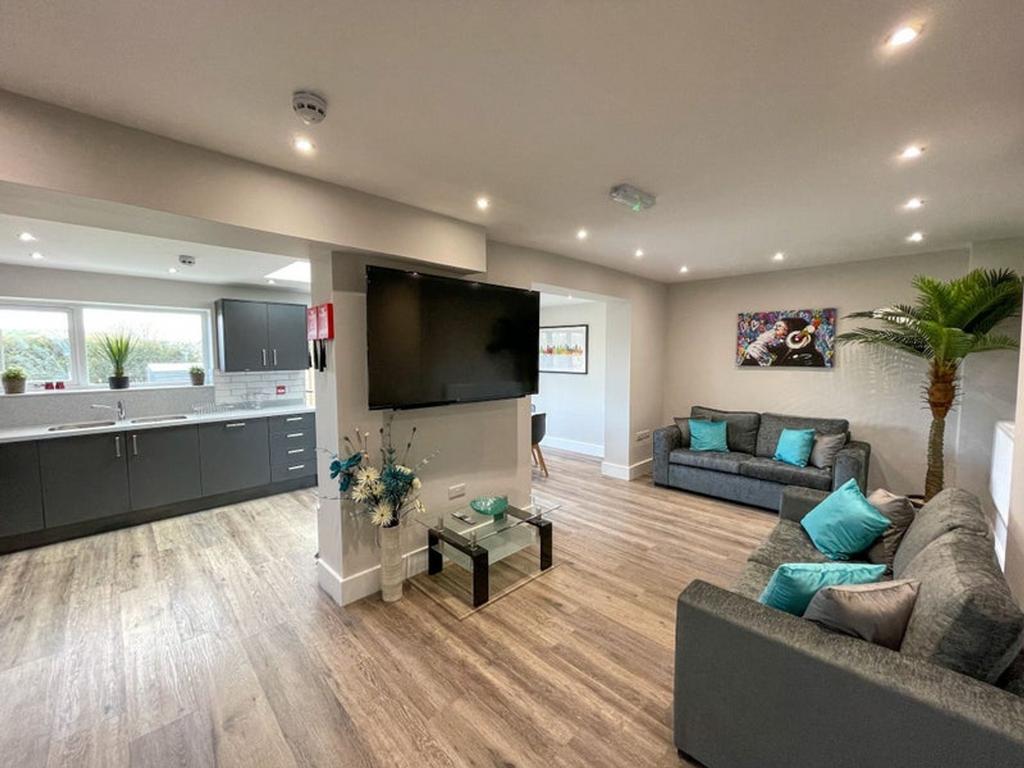 A spacious and modern living room featuring sty...