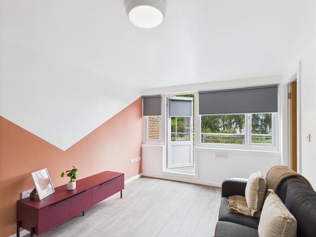 Bright contemporary living room with large wind...