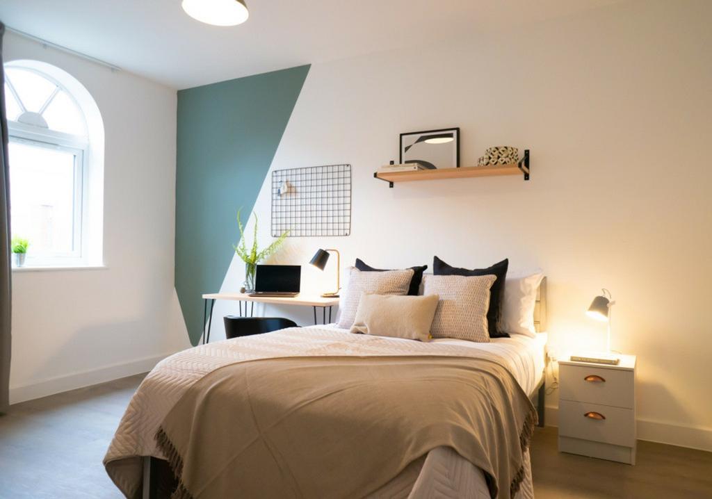 A bright and inviting double bedroom featuring ...