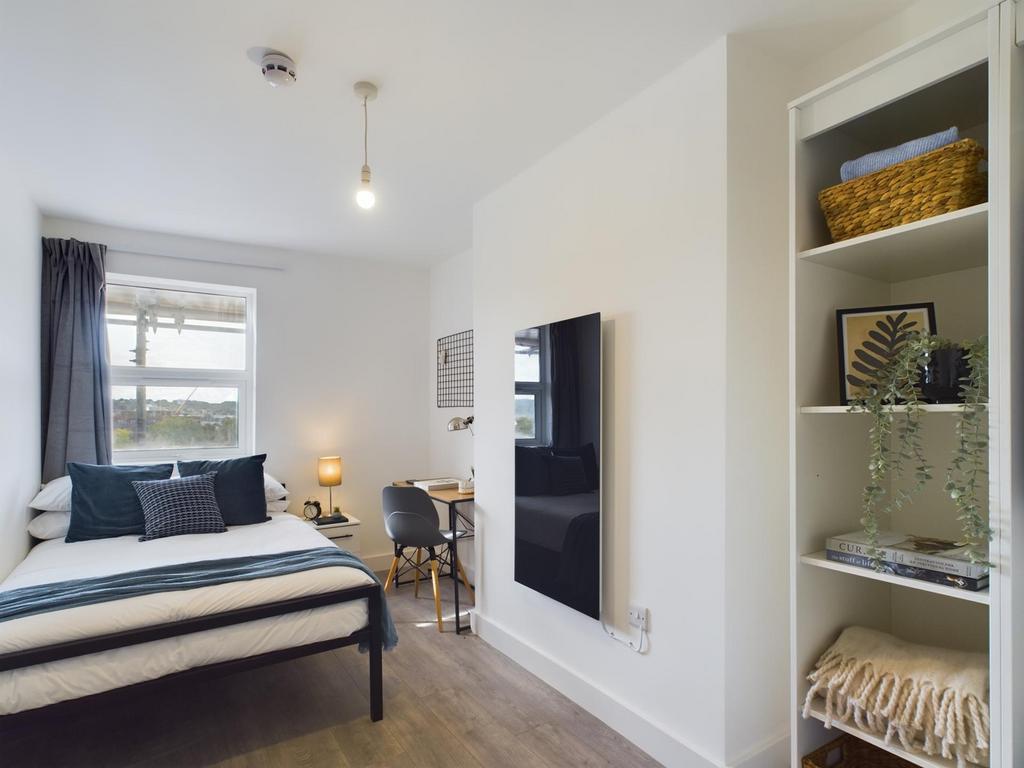 A bright and inviting double bedroom with moder...