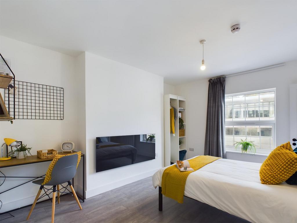 A bright and inviting double bedroom with moder...