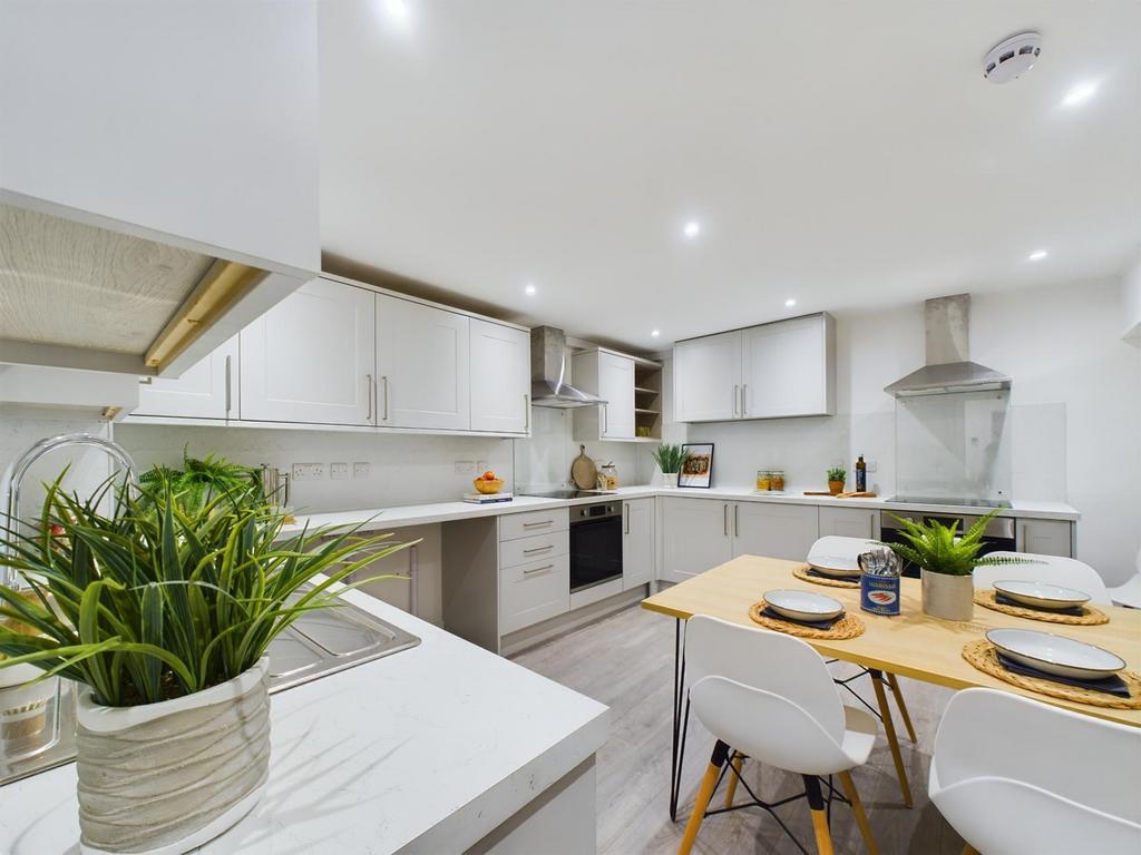 A bright and modern kitchen featuring ample spa...