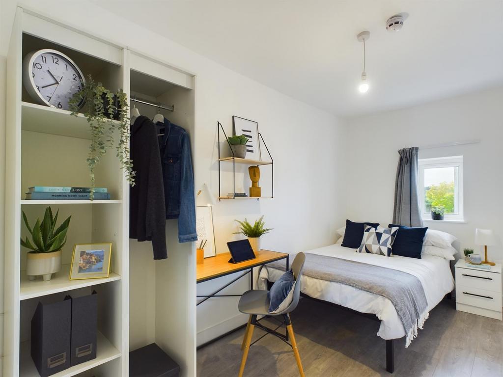 A bright and inviting double bedroom featuring ...