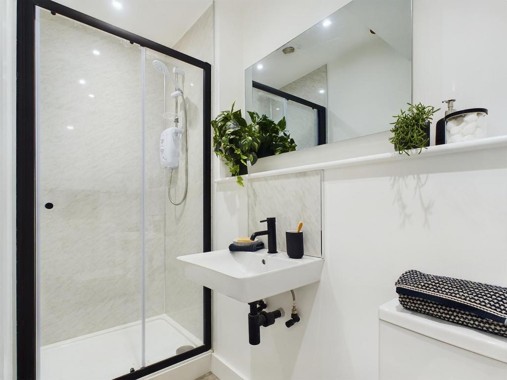 A modern and immaculate bathroom featuring a st...