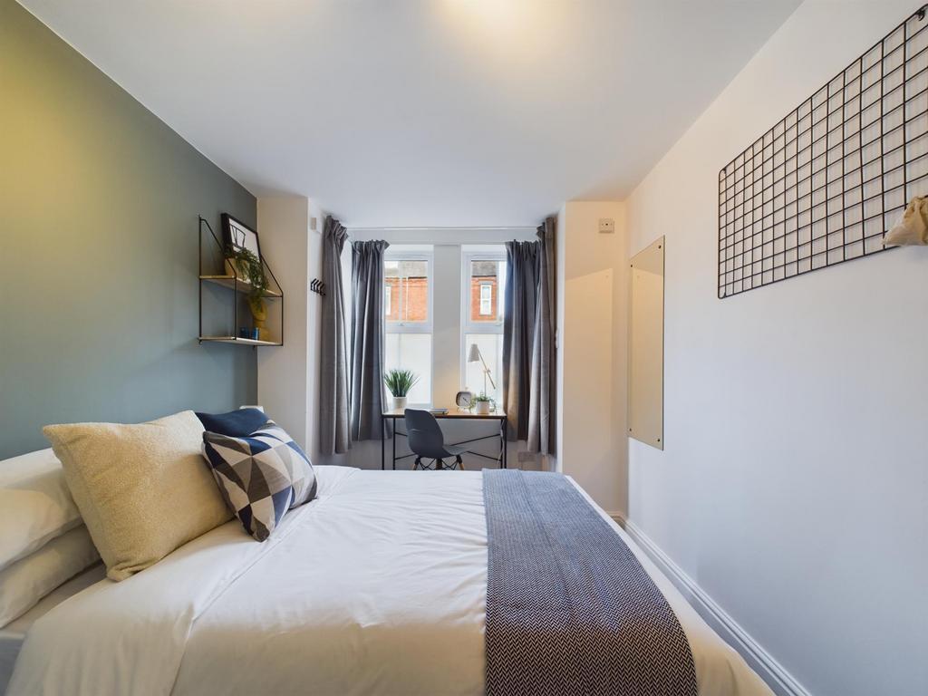 A bright and inviting master bedroom featuring ...