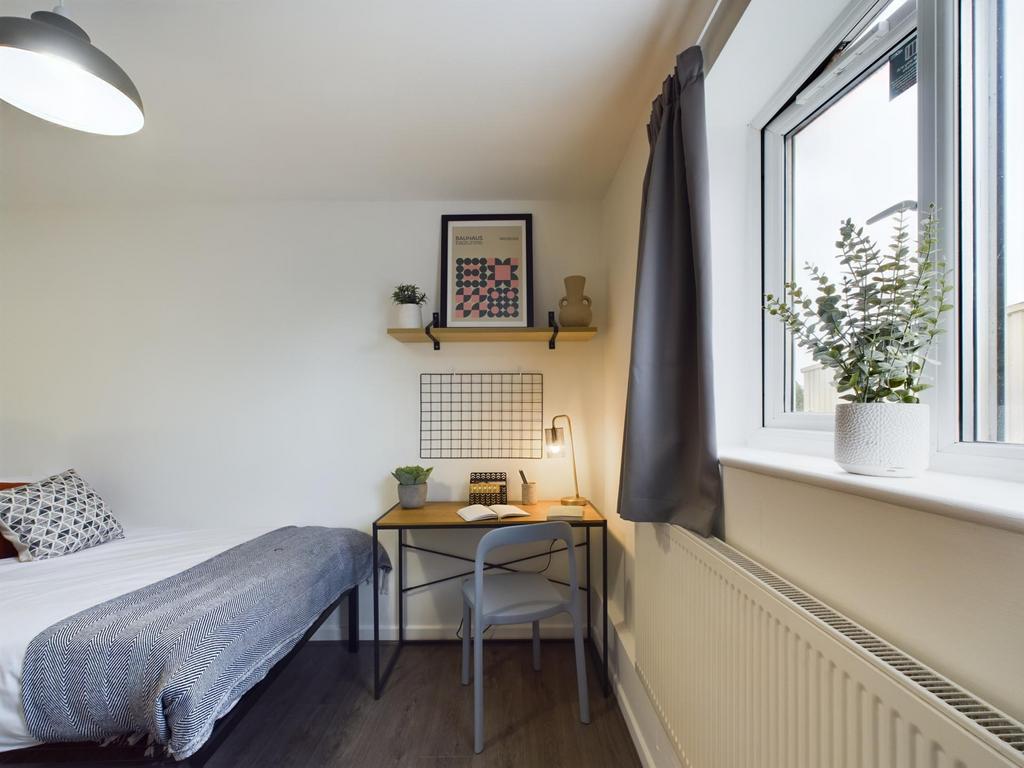 A cozy and well-maintained bedroom featuring a ...