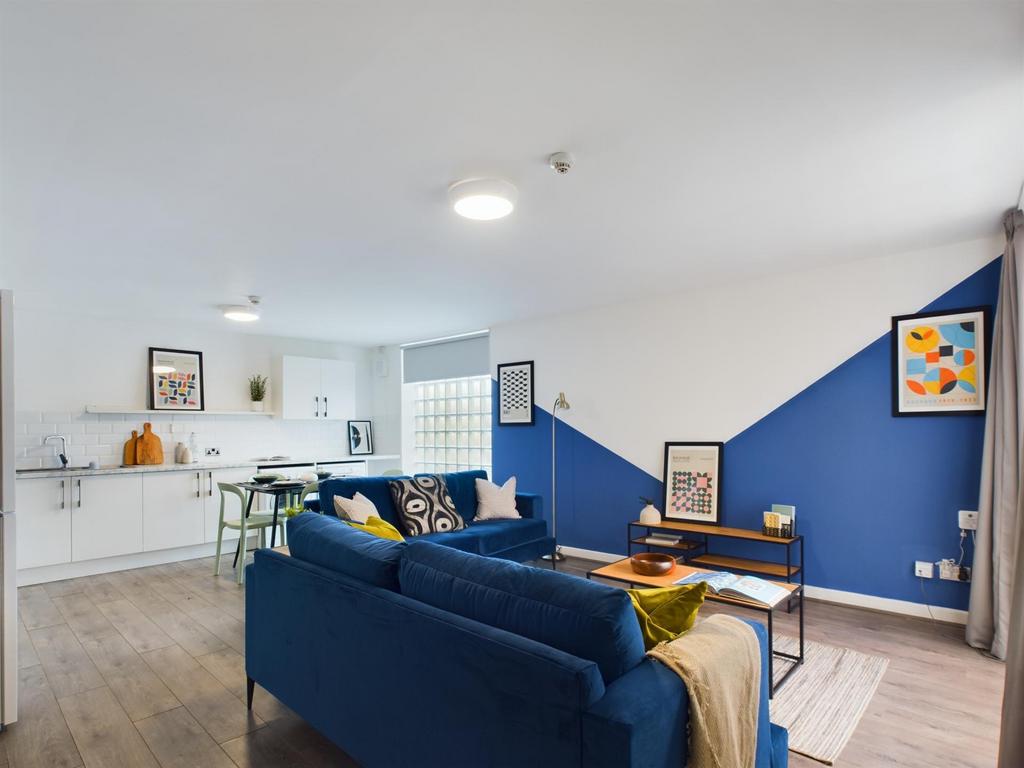 A modern, well-lit living room featuring a comf...