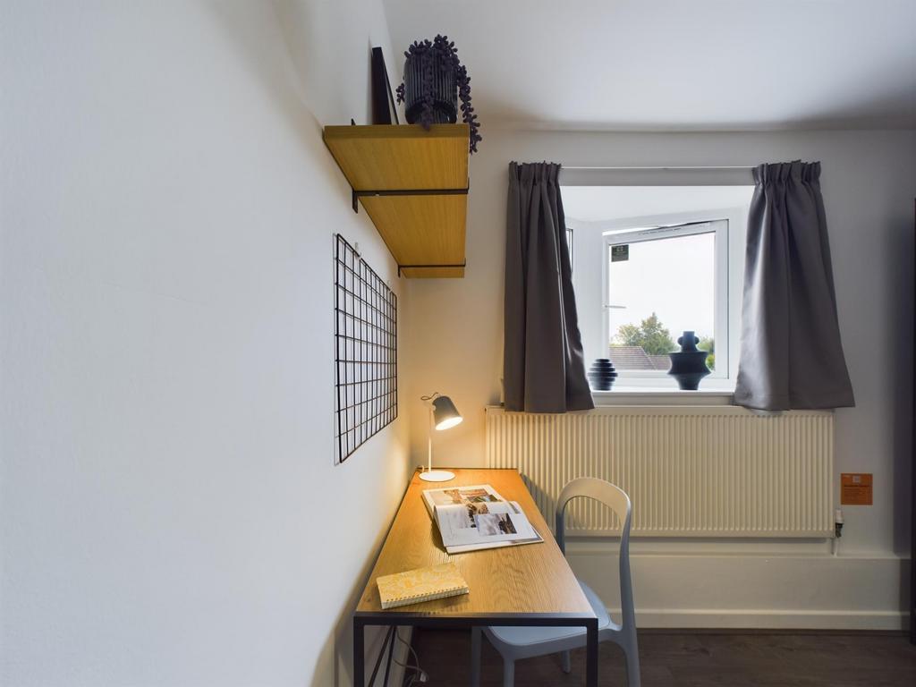 Compact, tidy single bedroom with a study desk,...