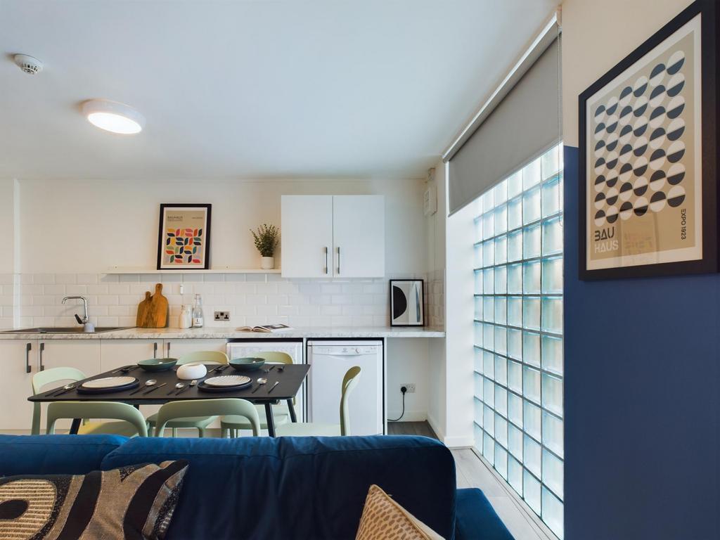 A bright and modern kitchen area featuring ampl...
