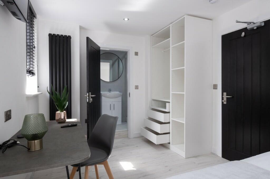 A stylish and tidy double bedroom equipped with...