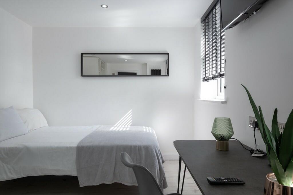 A bright and inviting double bedroom featuring ...