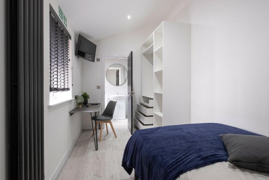 A bright and stylish double bedroom with modern...