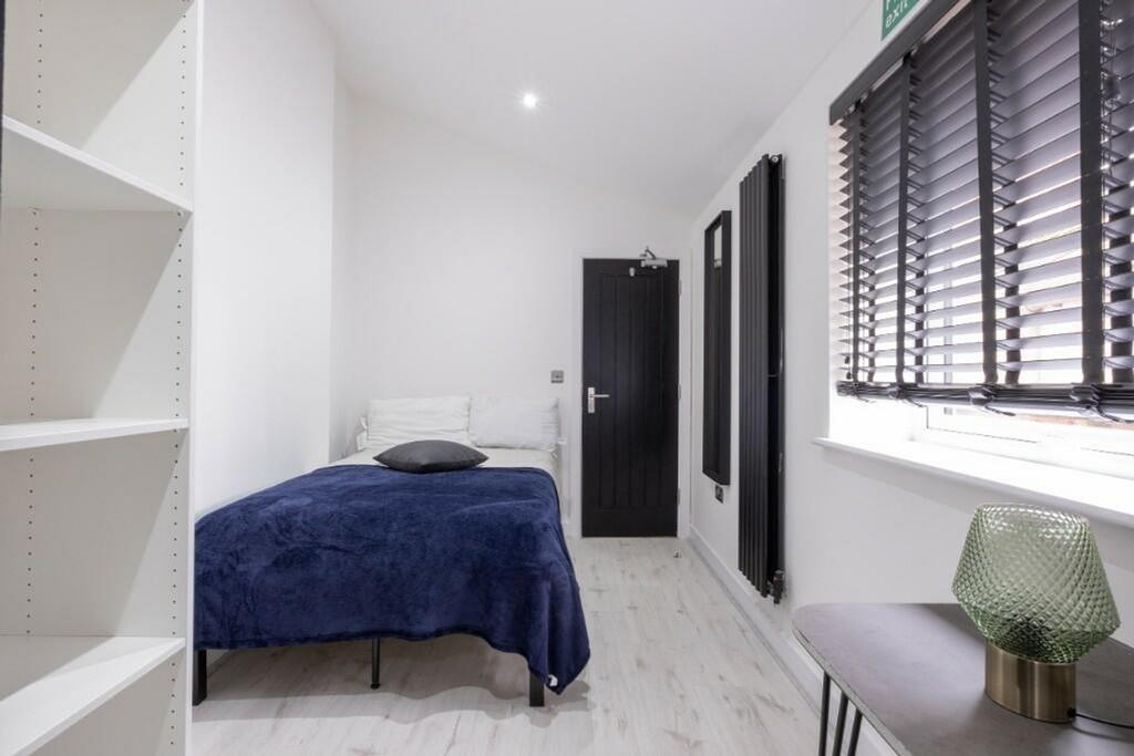 A modern and inviting double bedroom with a coz...