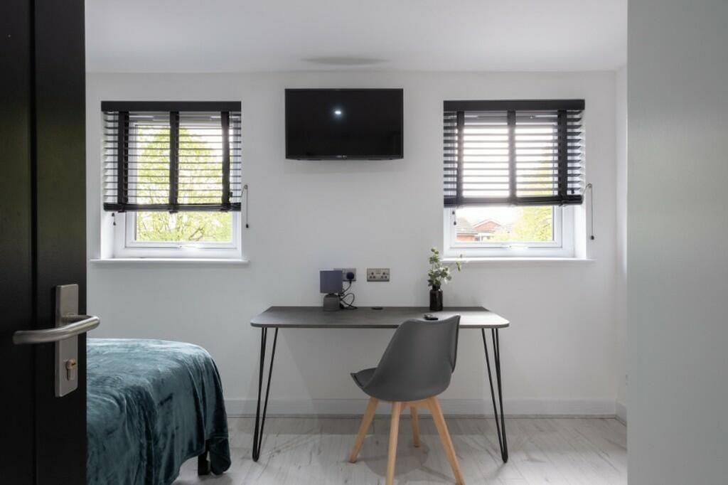 A stylish and well-lit double bedroom featuring...