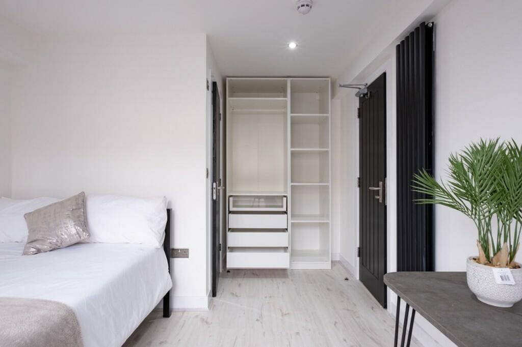 A modern and spacious double bedroom featuring ...