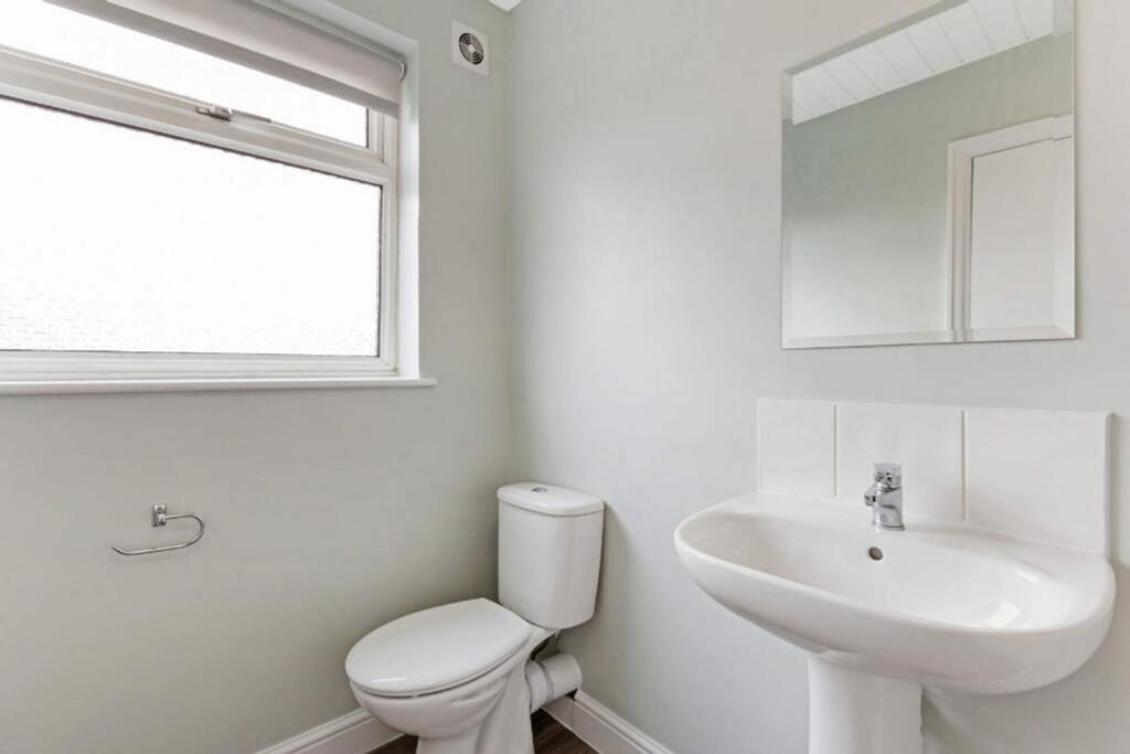 A bright and modern bathroom featuring a sleek ...