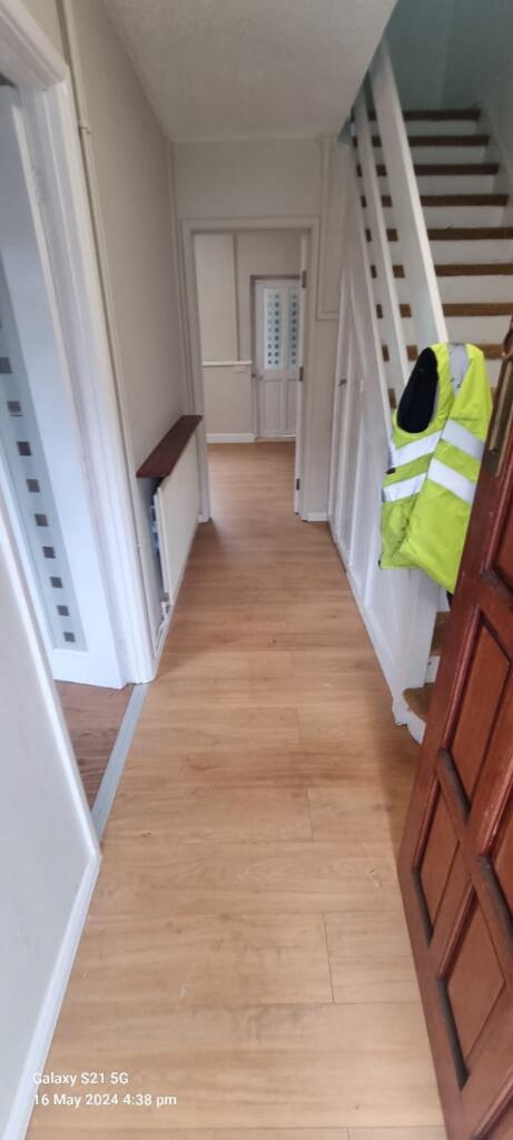 A welcoming hallway featuring wooden flooring t...