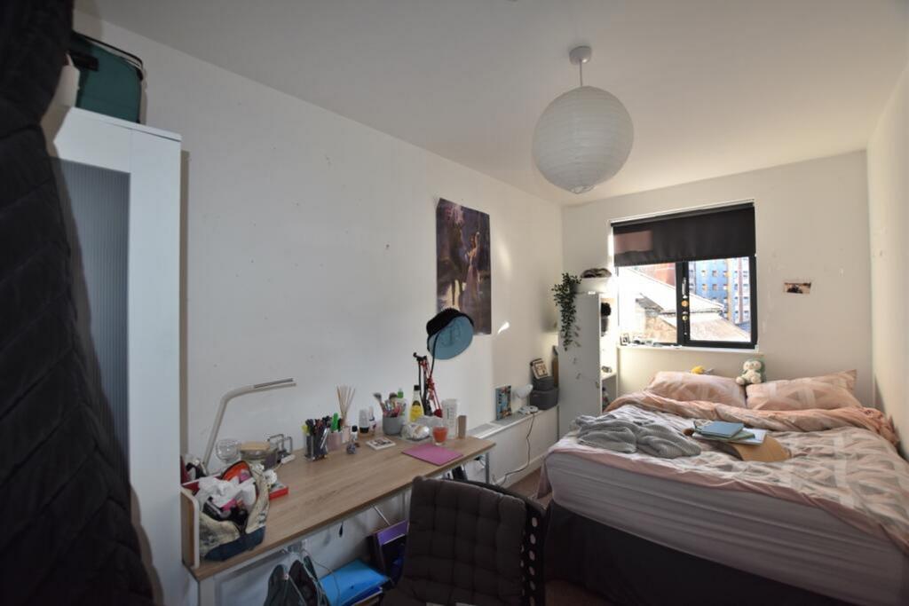 A cozy double bedroom featuring a comfortable b...