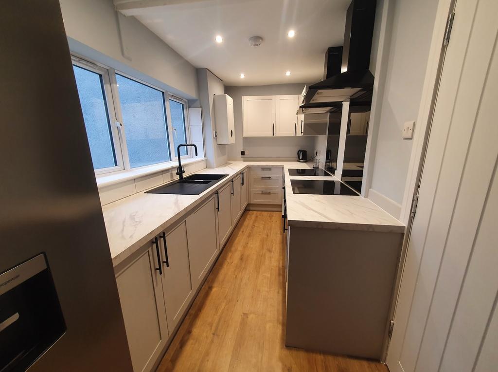 Modern kitchen featuring sleek cabinetry, ample...