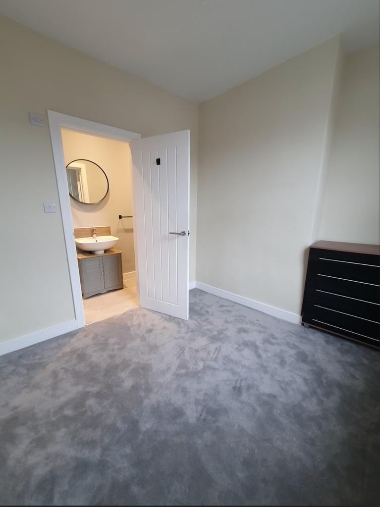 Spacious double bedroom featuring plush carpeti...