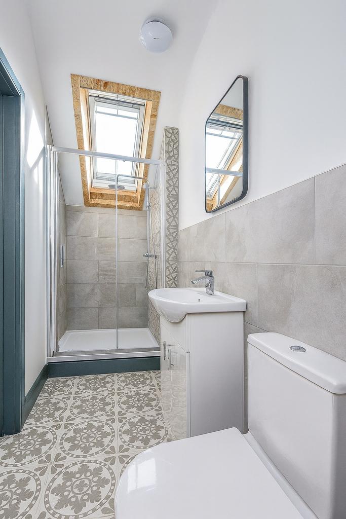 Bright and modern bathroom featuring a skylight...