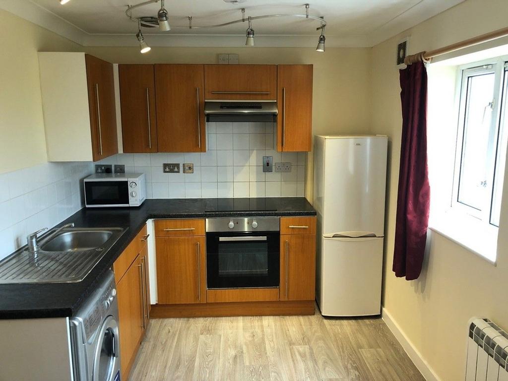 This modern kitchen features stylish wooden cab...