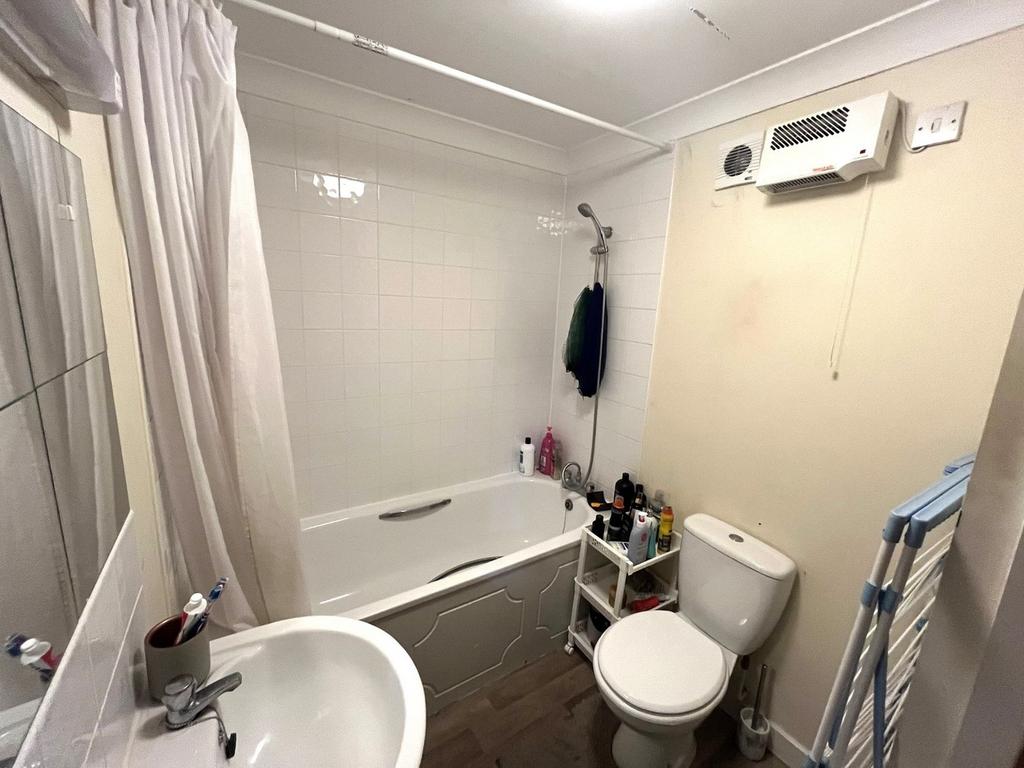This well-maintained bathroom features a modern...