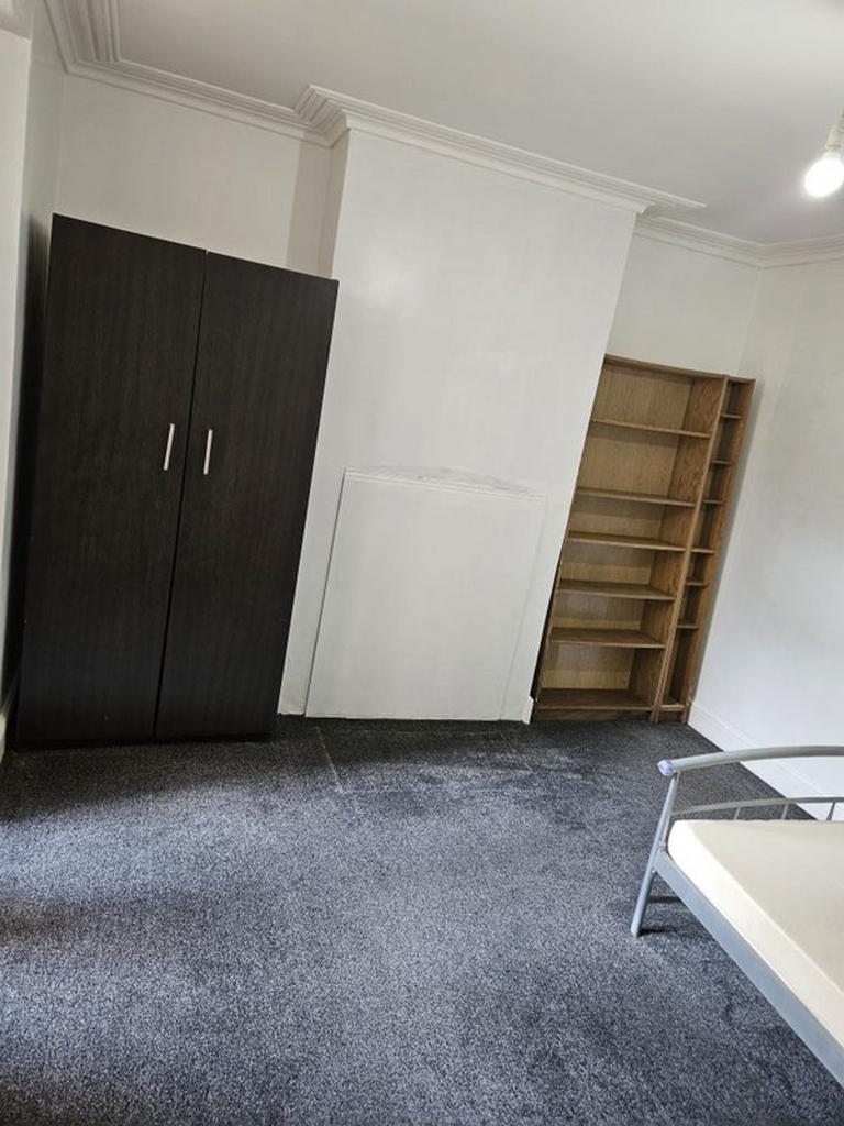 Spacious double bedroom featuring ample storage...