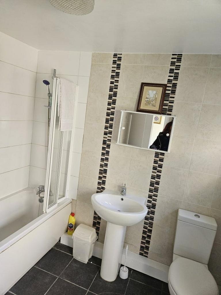 A modern bathroom featuring a stylish bathtub a...